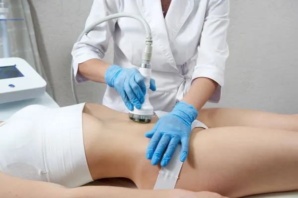 Lost the Weight but Not the Loose Skin? 2 woman having HIFU treatment on her stomach to combat loose skin Highworth following weight loss